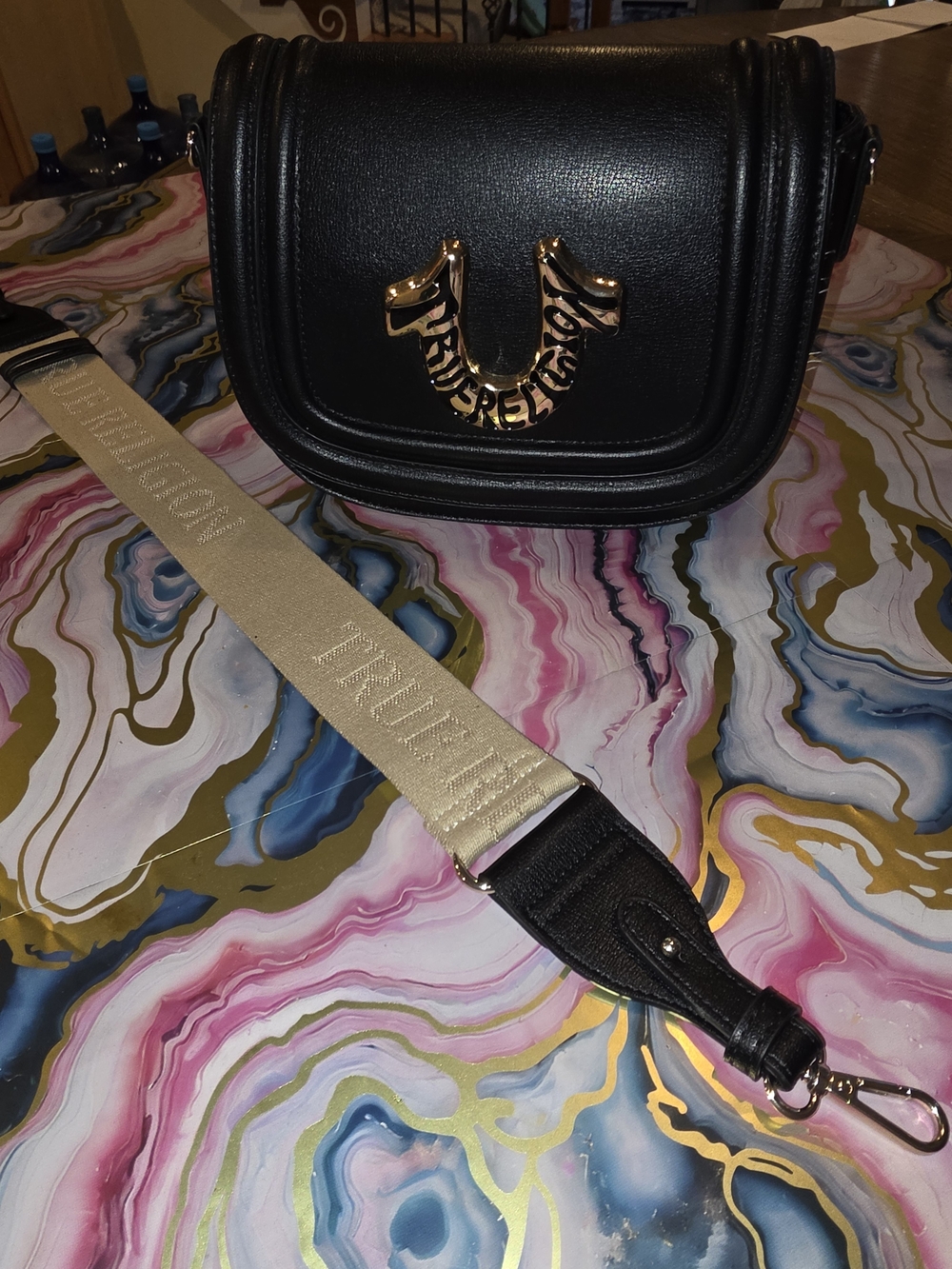 True Religion Black Crossbody Bag with Gold Logo and Beige Strap